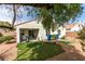 Inviting backyard with patio, artificial turf, and convenient access from the home at 3561 Cherbourg Ave, Las Vegas, NV 89141