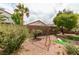 Spacious backyard features desert landscaping, mature trees, brick walls, and a putting green at 3561 Cherbourg Ave, Las Vegas, NV 89141