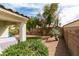 Secluded backyard features rock garden, grass area, and privacy wall at 3561 Cherbourg Ave, Las Vegas, NV 89141