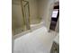 This bathroom features a tiled shower, a bathtub, and a door leading to another room at 3561 Cherbourg Ave, Las Vegas, NV 89141