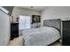 Bright bedroom features a decorative gray headboard, cozy white bedding, and natural light at 3561 Cherbourg Ave, Las Vegas, NV 89141