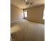 Large carpeted bedroom with a ceiling fan and bright windows at 3561 Cherbourg Ave, Las Vegas, NV 89141