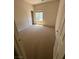 Bedroom with carpet, window with blinds, and open white doors at 3561 Cherbourg Ave, Las Vegas, NV 89141