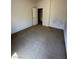 A spacious, empty bedroom with carpet and an open door at 3561 Cherbourg Ave, Las Vegas, NV 89141