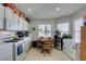 Bright kitchen area with a breakfast table, ample cabinets, and white appliances at 3561 Cherbourg Ave, Las Vegas, NV 89141