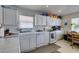 Functional kitchen featuring white appliances, tile countertops, and ample cabinet space at 3561 Cherbourg Ave, Las Vegas, NV 89141