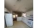 Bright kitchen with white cabinets, appliances and tile flooring at 3561 Cherbourg Ave, Las Vegas, NV 89141