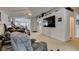 Open living room with ceiling fan and view to kitchen area at 3561 Cherbourg Ave, Las Vegas, NV 89141