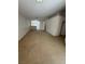 Spacious living room featuring neutral carpet, ceiling fan, and ample natural light at 3561 Cherbourg Ave, Las Vegas, NV 89141