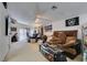 Spacious living room with vaulted ceilings, ceiling fan, and comfortable seating at 3561 Cherbourg Ave, Las Vegas, NV 89141