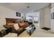 Spacious living room showcasing large sofa, access to the kitchen, and comfortable seating at 3561 Cherbourg Ave, Las Vegas, NV 89141