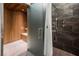 Modern bathroom with a glass-enclosed sauna and shower featuring wood and tile accents at 3726 Las Vegas Blvd # 2504, Las Vegas, NV 89158