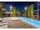 Luxurious rooftop pool with city views, lounge chairs, and modern architectural details at twilight at 3726 Las Vegas Blvd # 2504, Las Vegas, NV 89158