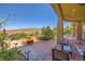 Inviting backyard with lush plants, patio seating, fire pit and mountain views at 4 Dry Brook Trl, Henderson, NV 89052