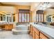 This bathroom features a bathtub, dual sinks, wood cabinets, and nice counters at 4 Dry Brook Trl, Henderson, NV 89052