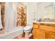 This bathroom features tile floors, a shower-tub combination, and oak cabinets at 4 Dry Brook Trl, Henderson, NV 89052