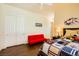 Bedroom featuring a bright red futon, ceiling fan, and large closet with folding doors at 4 Dry Brook Trl, Henderson, NV 89052