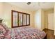 This bedroom features wood floors, a ceiling fan, and plantation shutters at 4 Dry Brook Trl, Henderson, NV 89052