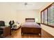 This bedroom features a ceiling fan, wood floors, and a comfortable seating area at 4 Dry Brook Trl, Henderson, NV 89052