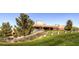 Well-maintained clubhouse with expansive green lawn, mature trees, and inviting outdoor seating areas at 4 Dry Brook Trl, Henderson, NV 89052