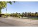 Scenic community entrance with lush landscaping, water feature, and clear signage at 4 Dry Brook Trl, Henderson, NV 89052