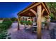 Relaxing outdoor gazebo with seating area surrounded by beautiful landscaping and garden views at 4 Dry Brook Trl, Henderson, NV 89052