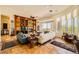 Cozy living area with built-in shelves, fireplace, and large windows offering natural light at 4 Dry Brook Trl, Henderson, NV 89052