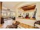 Spacious living area with large windows and open floor plan with wood beam accents at 4 Dry Brook Trl, Henderson, NV 89052