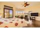 This main bedroom features a fireplace, wood floors, and a seating area at 4 Dry Brook Trl, Henderson, NV 89052