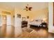 This main bedroom features wood floors, a ceiling fan, and neutral decor at 4 Dry Brook Trl, Henderson, NV 89052
