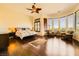 Spacious main bedroom with hardwood floors, ceiling fan, and an abundance of natural light at 4 Dry Brook Trl, Henderson, NV 89052