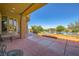 Spacious covered patio with views of the pool, landscaped backyard, and scenic mountains at 4 Dry Brook Trl, Henderson, NV 89052