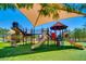 Vibrant playground with colorful equipment, shaded seating, and ample space for activities at 4 Dry Brook Trl, Henderson, NV 89052