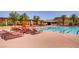 Community pool with lounge chairs and shaded areas, perfect for relaxation and recreation at 4 Dry Brook Trl, Henderson, NV 89052
