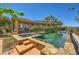 Inviting backyard pool and spa with lush landscaping and covered patio area, perfect for outdoor relaxation at 4 Dry Brook Trl, Henderson, NV 89052