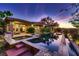Inviting pool area with custom tile work, water feature, and covered outdoor space at 4 Dry Brook Trl, Henderson, NV 89052