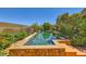 Inviting pool with spa, lush landscaping, and serene views for relaxation and outdoor enjoyment at 4 Dry Brook Trl, Henderson, NV 89052