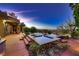 Twilight view of the modern pool and spa area, showcasing the outdoor living space at 4 Dry Brook Trl, Henderson, NV 89052