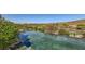 An infinity pool showcases stunning city views and mature landscaping at 4 Dry Brook Trl, Henderson, NV 89052