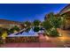 Night view of pool and spa with beautiful backyard lighting, landscaping, and outdoor appeal at 4 Dry Brook Trl, Henderson, NV 89052
