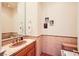 Elegant powder room features modern fixtures, a stylish mirror, and a tiled backsplash at 4 Dry Brook Trl, Henderson, NV 89052
