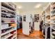 A large walk-in closet features custom shelving and wood floors at 4 Dry Brook Trl, Henderson, NV 89052
