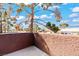 Private balcony with views of the surrounding neighborhood, blue skies, and mature landscaping at 4050 Pacific Harbors Dr # 229, Las Vegas, NV 89121