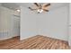 The expansive main bedroom boasts hardwood floors, a ceiling fan, and large windows at 4050 Pacific Harbors Dr # 229, Las Vegas, NV 89121