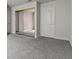 A bright bedroom features a mirror closet and a white door at 4050 Pacific Harbors Dr # 229, Las Vegas, NV 89121