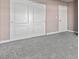 A bedroom with carpet has white closet doors and a white door to another room at 4050 Pacific Harbors Dr # 229, Las Vegas, NV 89121