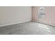A bedroom features a window, carpet, and neutral-colored walls at 4050 Pacific Harbors Dr # 229, Las Vegas, NV 89121