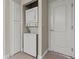 Compact laundry area with stacked washer/dryer and storage cabinet adjacent to a door at 4050 Pacific Harbors Dr # 229, Las Vegas, NV 89121