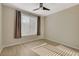 Comfortable bedroom features neutral walls, flooring, and a ceiling fan for added comfort at 4400 S Jones Blvd # 2103, Las Vegas, NV 89103