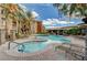 Gorgeous community pool with ample seating and a spa, surrounded by lush landscaping and palm trees at 4400 S Jones Blvd # 2103, Las Vegas, NV 89103